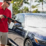 Leoserve technician applying foam-cannon soap to a car in the Florida Keys before a DI-water hand wash