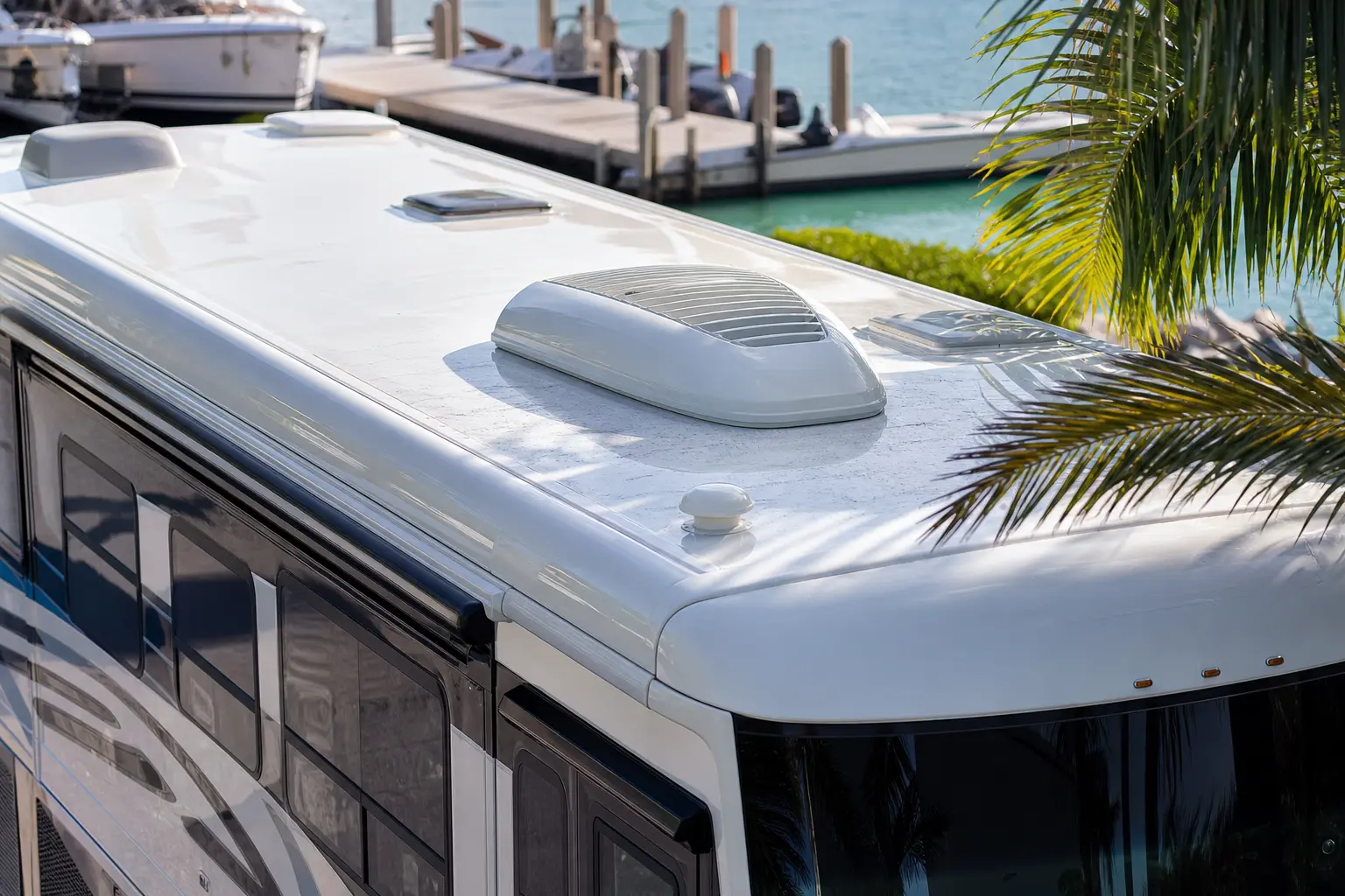 Close-up of a high-end Class A motorcoach roof with premium roof fittings and light Florida Keys salt residue.