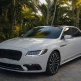 Clean pearl-white sedan parked in a shaded tropical Florida Keys driveway after a professional detail