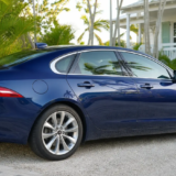 A freshly detailed deep-blue sedan in soft Key West afternoon light.
