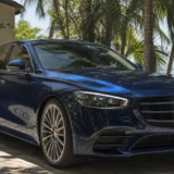 Glossy dark-blue sedan parked in a shaded Florida Keys driveway after exterior detailing